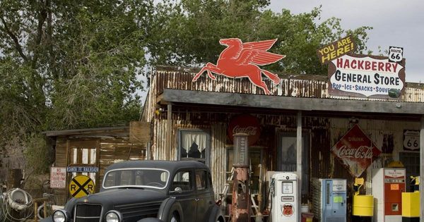 Hackberry General Store storefront on Route 66 with Pegasus sign, vintage gas pumps, and a classic car parked out front