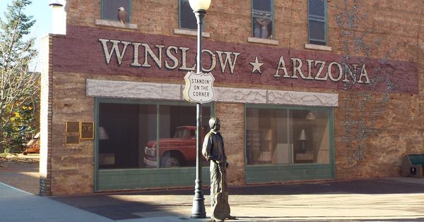 The Standin' on the Corner statue, lamppost, and Winslow Arizona mural at the park in Winslow